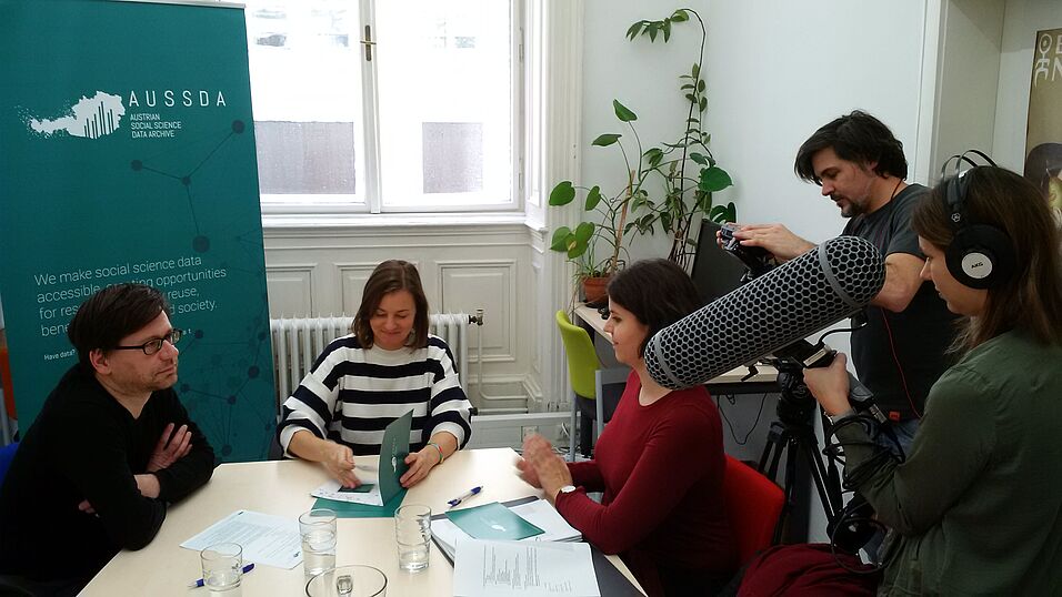 People being filmed in a meeting room